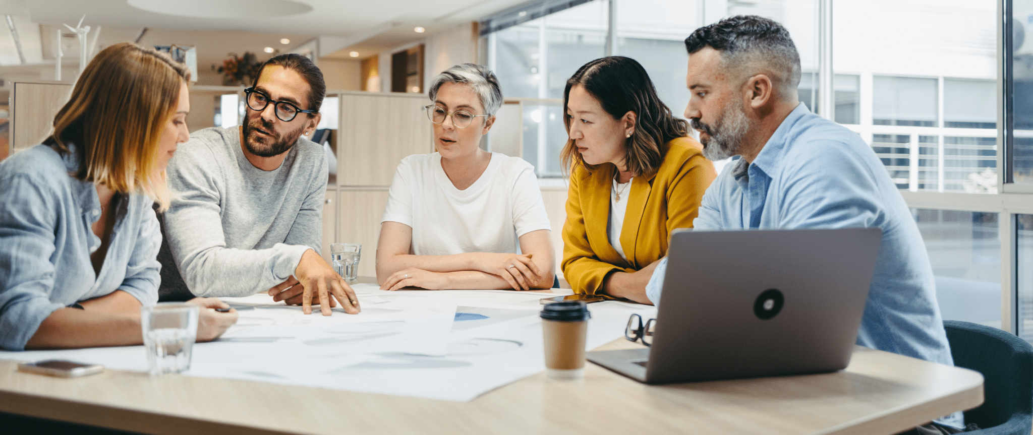 Group of workers discussing in a meeting while planning strategies