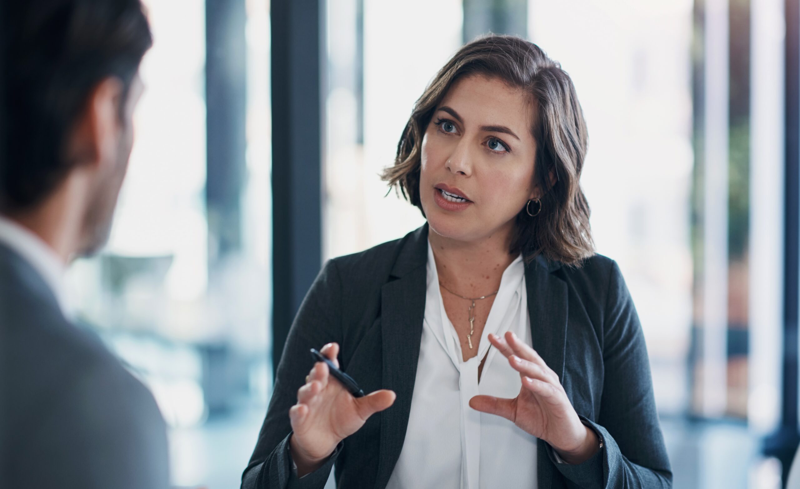 Business man, woman and interview in discussion for deal, agreement or contract for b2b collaboration. People, staff and meeting with negotiation for questions, human resources or decision in office