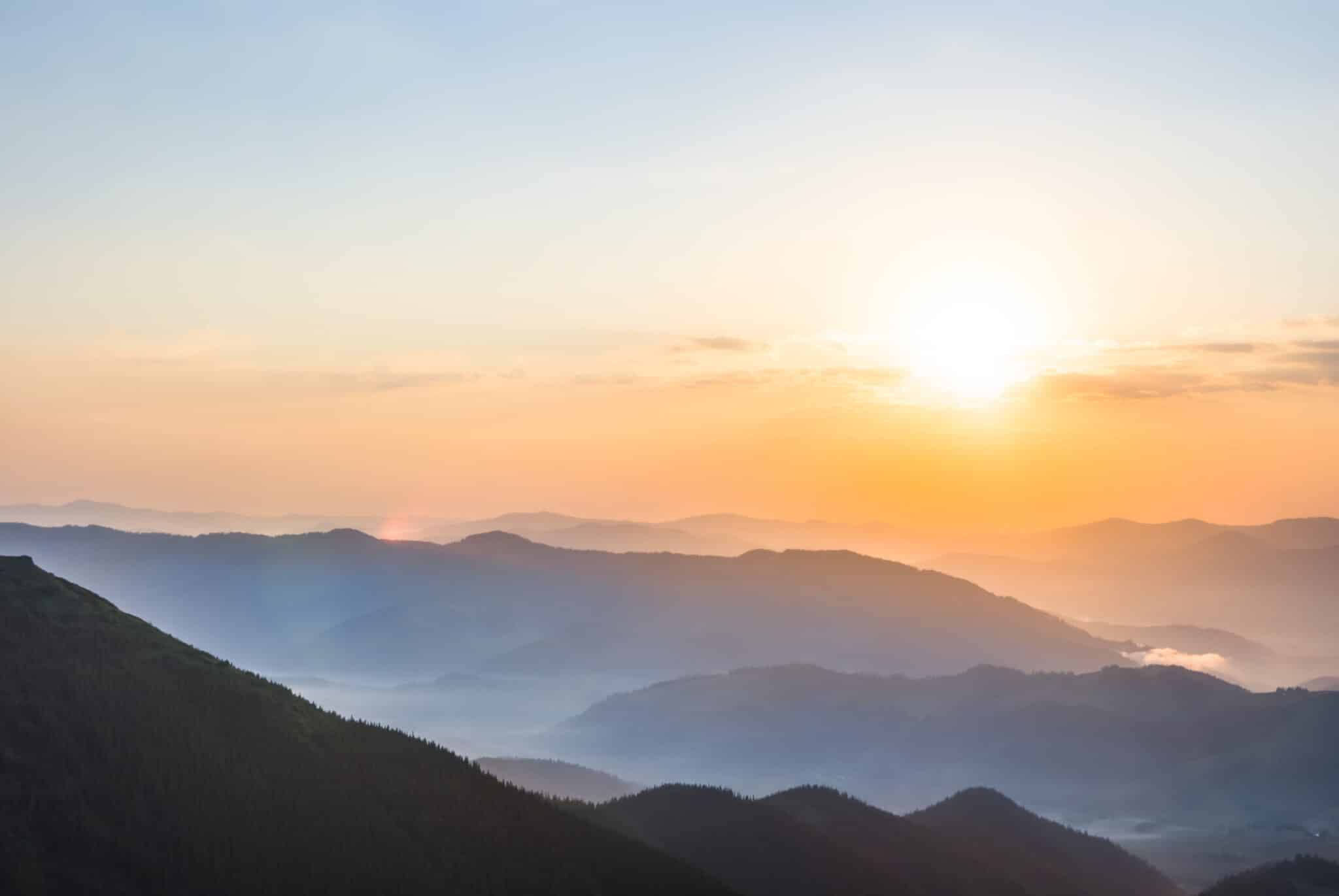 Early morning sunrise over a misty mountain valley