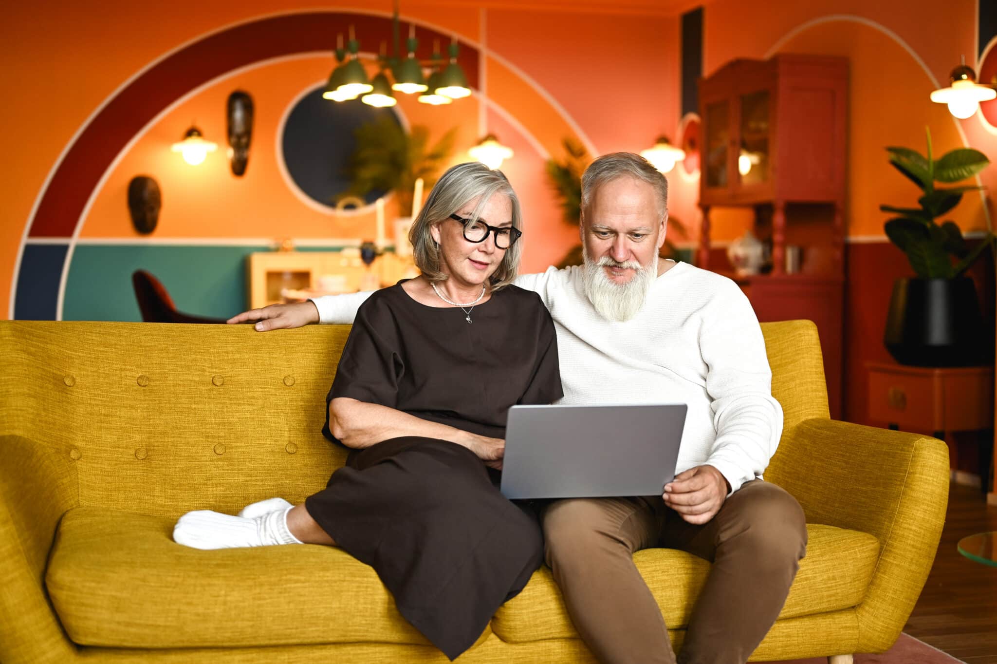 A couple in their sixties having an online client feedback conversation